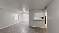Located at 942 Simpson Terr in Bedford, TX, this single-floor, 2-bedroom, 2-bathroom home offers a well-organized layout designed for comfortable everyday living. The open-concept living and dining area is finished with wood-look plank flooring and features a textured ceiling with a ceiling fan, natural light from a window, and clean neutral walls. A half-wall pass-through with a stone tile accent and granite-style countertop connects the living and dining space to the kitchen, which is equipped with white cabinetry and black appliances. The dining area is accented with classic beadboard wainscoting, adding a touch of character. The spacious primary bedroom features plush carpeting, a ceiling fan, and a sliding glass door that opens to an outdoor area. The second bedroom also includes wood-look flooring, a ceiling fan, and a window for natural light. Both bathrooms are well-appointed; one features large-format subway tile in the tub surround with matching wood-look flooring. A dedicated laundry area adds functional convenience. The consistent use of neutral tones, wood-look flooring, and clean finishes throughout creates a cohesive and move-in ready atmosphere.