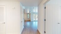Located on Garwood Way in Menlo Park, California, this thoughtfully designed single-floor residence offers a clean, modern aesthetic with an open and airy feel. Light-toned hardwood flooring flows seamlessly throughout the space, complemented by crisp white walls and abundant natural light streaming through multiple windows that frame pleasant views of surrounding greenery.

The open living area is spacious and versatile, featuring a built-in shelving unit that serves as a functional room divider, providing both storage and a dedicated media wall. The well-appointed kitchen is a standout feature, showcasing two-tone wood cabinetry in warm and cool finishes, light quartz countertops, a subway tile backsplash with under-cabinet LED lighting, and stainless steel appliances including a gas range, microwave, and full-size refrigerator.

The bedrooms are bright and generously sized, each benefiting from large windows that invite natural light and outdoor views. The bathrooms are finished in a clean, minimal palette — one featuring a glass-enclosed walk-in shower with chrome fixtures, and another offering a soaking tub, a wood-vanity with an illuminated mirror, and mosaic tile flooring. A welcoming entry hallway with interior doors completes the thoughtful layout of this well-crafted Menlo Park residence.