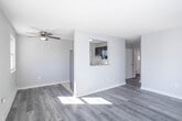 Located at 112 Atlantic Ave in Pleasantville, NJ, this one-bedroom, one-bathroom unit offers a well-organized, single-floor layout that makes efficient use of its space. The combined kitchen and living room serves as the heart of the home, featuring light gray laminate wood flooring that flows throughout and a ceiling fan that adds both comfort and a subtle design touch. Large windows along the living area's front wall flood the space with natural light, offering views of the surrounding neighborhood and creating a bright, airy atmosphere. Baseboard heating is present throughout.

The kitchen is separated by a partial wall with a pass-through window, giving the space an open, connected feel. It is equipped with slate-blue cabinetry, white subway tile backsplash, a stainless steel refrigerator, and a range, all complemented by a window for additional natural light.

The bedroom is a comfortable, well-proportioned room with its own ceiling fan, a window with outdoor views, and a closet for ample storage. The clean, neutral walls provide a calm and versatile backdrop.

The bathroom is bright and simply appointed, featuring white tile walls, a window, a vanity, and wood-look flooring. A hallway connects all rooms, completing this practical and move-in-ready home.