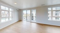 This contemporary apartment in Salt Lake City offers 1180 square feet of thoughtfully designed living space. The open-concept layout seamlessly integrates the kitchen, living, and dining areas, creating a spacious feel. The gourmet kitchen is a highlight, featuring sleek white cabinetry, stainless steel appliances, and a large island with pendant lighting. Light wood flooring throughout adds warmth to the crisp, white interiors.

Both bedrooms are generously sized, with the primary bedroom boasting 160 square feet. Large windows in every room flood the space with natural light and frame city views. The two bathrooms are modern and stylish, with one featuring a walk-in shower and built-in shelving.

A standout feature is the private balcony, offering panoramic views of the surrounding cityscape and distant mountains. The apartment complex includes attractive amenities such as a pool, visible from some units. With its prime location at 2154 South Highland Drive, this apartment combines urban convenience with contemporary comfort.