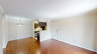 This single-story, one-bedroom, one-bathroom unit in Houston, Texas offers a well-organized layout designed to maximize functionality. The living area is a welcoming space featuring rich hardwood-style flooring, crown molding, and neutral-toned walls that create a bright, clean atmosphere. A full-length sliding glass door fitted with vertical blinds opens to a balcony, allowing natural light to fill the room and providing outdoor views of the surrounding community.

The kitchen is positioned adjacent to the living area, separated by a half-wall breakfast bar that maintains an open connection between the two spaces. It is equipped with dark espresso-toned cabinetry, light granite-style countertops, stainless steel appliances including a refrigerator and range, and tile flooring, offering a practical and cohesive workspace.

The bedroom is a generously sized, carpeted retreat featuring a ceiling fan with integrated lighting, a window for natural light, and neutral walls that lend a calm, restful ambiance.

The full bathroom includes a tub-shower combination, a dark-cabinetry vanity with matching granite-style countertop, tile flooring, and ample overhead storage, completing this efficiently designed unit.