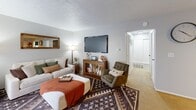 Located at 6009 Lake Club Court in Columbus, Ohio, this single-floor 1-bedroom unit offers a well-organized layout comprising a living room, kitchen, bedroom, and hallway. The living room serves as the heart of the home, featuring a textured ceiling, neutral walls, and carpet flooring. A large window with sheer curtains allows natural light to fill the space, complementing the warm, inviting atmosphere. The room provides ample space for a full seating arrangement and media setup.

The kitchen is outfitted with dark cabinetry offering generous storage, dark countertops, a stainless steel sink, and white appliances including a dishwasher. The functional layout makes efficient use of the available space.

The bedroom is a comfortable, well-proportioned retreat featuring carpet flooring, a textured ceiling, and a window with blinds that brings in natural light. A sliding closet door adds practical storage. The neutral gray walls create a calm, restful environment.

A hallway connects the main areas of the unit, providing a clear and logical flow throughout the space. Overall, the unit presents a compact yet functional floor plan well-suited for single occupancy or as a starter home in Columbus, OH.