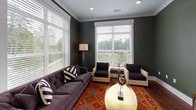 Located at 1310 Iris Dr in Charlotte, NC, this thoughtfully designed single-floor residence offers a cohesive blend of modern finishes and comfortable living spaces throughout. The open layout connects key areas seamlessly, as seen in the 3D floor plan overview.

The kitchen is a standout feature, showcasing tall white shaker cabinetry with glass-front upper panels, grey quartz countertops, stainless steel appliances including a double wall oven and built-in microwave, and a striking mosaic tile backsplash framing a statement range hood. Rich hardwood flooring and a breakfast bar with seating add both warmth and functionality.

The living room is distinguished by deep green walls, large windows with neighborhood views, hardwood floors, crown molding, and recessed lighting, creating a bold yet inviting atmosphere.

The bedrooms feature soft carpet, tray ceilings with ceiling fans, and large windows that bring in natural light. The primary bath offers a dual-sink vanity with dark countertops, a soaking tub, and a tiled shower. A secondary bathroom includes a single vanity with dark countertops and a glass-enclosed shower. Throughout, soft grey tones and clean white trim lend the home a polished, cohesive character.