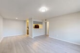 Located at 10615 Meadowglen Ln in Houston, TX, this one-bedroom, one-bathroom residence offers a well-organized single-floor layout designed for comfortable everyday living. Light wood-style flooring runs throughout, giving the entire space a clean, cohesive look. The open living and dining area is bright and inviting, with neutral gray walls, a textured ceiling, and a window that draws in natural light. A pass-through opening connects the living space to the kitchen, creating an open and communicative feel. The galley-style kitchen is efficiently designed, featuring marble-look quartz countertops, a mosaic tile backsplash, gray cabinetry, and stainless steel appliances including a refrigerator, dishwasher, and range. A pantry provides additional storage just off the kitchen. The bedroom is a comfortable size, featuring a window with outdoor views, a closet with built-in shelving, and continued wood-style flooring. The unit also benefits from four closets total, offering generous storage throughout. The bathroom includes a single vanity with a marble-look countertop, an undermount sink, and a tiled shower-tub combination. A dedicated laundry area and a hallway complete the layout, making this a fully functional and move-in ready residence.
