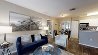 Located in Orlando, FL (32825), this well-appointed 2-bedroom, 2-bathroom single-floor residence features a cohesive, modern design throughout. Wood-style flooring flows seamlessly across all rooms, creating a warm and unified aesthetic. The open-concept living and dining area is bright and inviting, with neutral-toned walls, a wall-mounted TV, and stylish furnishings that maximize the sense of space. The kitchen is well-equipped with white cabinetry, granite-style countertops, stainless steel appliances, and a peninsula that opens to the living area. Both bedrooms are generously sized with windows that frame green outdoor views and offer ample closet storage. One bedroom includes a dedicated home office setup with dual windows, a ceiling fan, and abundant natural light—ideal for remote work. The two bathrooms are clean and functional; one features a soaking tub and shower combo, while the other includes a streamlined vanity with linen storage. Warm neutral tones and consistent finishes throughout the home contribute to a polished, move-in-ready atmosphere.