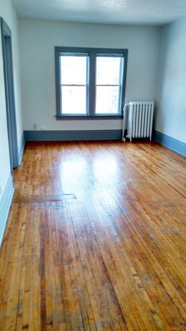 Living room with original hardwood floors - 1818 W Minnehaha Ave