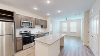 Located at 790 Smyrna Hill Dr SE in Smyrna, Georgia, this well-appointed 2-bedroom, 2-bathroom residence offers a thoughtfully designed single-level layout. The open-concept kitchen is a standout feature, showcasing rich dark-brown cabinetry, granite countertops, a large central island, and a full suite of stainless steel appliances including a refrigerator, range, microwave, and dishwasher. Recessed lighting illuminates the space, which flows seamlessly into the living area, complete with a ceiling fan and multiple windows that invite natural light. Light wood-look flooring runs consistently throughout the home, creating a cohesive and modern aesthetic. The primary bedroom is generously sized, featuring a ceiling fan, natural light from a window, and access to a dedicated bathroom with a granite-topped vanity, a large mirror, and a tub-shower combination outfitted with brushed nickel grab bars. The second bedroom also benefits from natural light through its own window. Additional conveniences include three closets, a laundry area, and a utility room, ensuring ample storage and functional living throughout.
