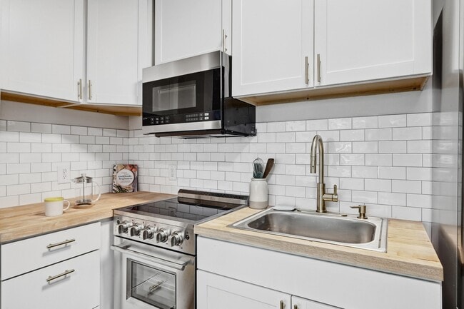 Kitchen with Microwave and 2025 Appliances - 2802 Whitis Avenue
