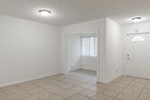 Located in Oakland Park, Florida, this single-story, 2-bedroom, 2-bathroom unit offers a practical and functional layout across a comfortable footprint. Light-toned ceramic tile flooring runs throughout the entire residence, creating a cohesive and easy-to-maintain living environment. The open living and dining areas flow naturally into one another, providing a versatile space for both relaxing and entertaining. A dedicated den adds flexibility, suitable for use as a home office or additional sitting room, and features a large window that brings in natural light. The kitchen is well-appointed with warm wood-toned cabinetry, granite-style countertops, and stainless steel appliances including an electric range and over-the-range microwave. The primary bedroom is generously sized with its own closet, while the second bedroom also includes closet storage and windows allowing natural light. In total, four closets are distributed throughout the unit, ensuring abundant storage. The two bathrooms are finished with warm golden tile work — one featuring a tub-shower combination with a window, and the other offering a walk-in shower. A utility room and hallway round out the layout, adding further practicality to this well-organized ground-floor home.