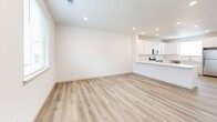 Located at 920 Cedar Pine Dr in Longmont, Colorado, this two-story home offers a clean, modern aesthetic throughout its two bedrooms and three bathrooms. The main floor is anchored by an open-concept layout that seamlessly connects the living room, dining area, and kitchen. Light luxury vinyl plank flooring runs throughout the main level, complementing the crisp white walls and recessed lighting that keep the space bright and airy. The kitchen is well-appointed with white shaker cabinetry, white quartz countertops, a central island, and a full suite of stainless steel appliances, including a range, microwave, dishwasher, and refrigerator. A sliding glass door off the kitchen provides access to the outdoors. The main floor also includes a hallway, a utility room, and a dedicated laundry room for added convenience. Upstairs, the primary bedroom is a comfortable retreat featuring plush carpeting, multiple windows that invite natural light and neighborhood views, a ceiling fan, and a sliding closet. The bathrooms carry the home's clean palette with white vanities, quartz countertops, and brushed nickel fixtures. Additional closets throughout provide ample storage, completing this well-organized and move-in-ready Longmont home.