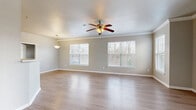 Located at 5386 E 81st St in Tulsa, Oklahoma, this single-story 2-bedroom, 2-bathroom home offers a thoughtfully designed layout across a comfortable footprint. The open-concept living, dining, and kitchen area serves as the heart of the home, featuring light wood-look flooring, crown molding, and a ceiling fan with light fixture. Multiple windows fill the space with natural light and offer views of the surrounding greenery. A pendant light marks the dining area, adding a refined touch to the open layout. The kitchen is equipped with light wood cabinetry, black appliances including a refrigerator, microwave, and range, and a peninsula breakfast bar that connects seamlessly to the living area. A pantry provides additional storage. The spacious primary bedroom features plush carpeting, a ceiling fan, and a built-in vanity area, with a private en-suite bathroom with light wood cabinetry and a tub-shower combo. The second bedroom also offers carpeted floors, a ceiling fan, and ample natural light. A second full bathroom includes a soaking tub. Both bedrooms are served by well-sized closets with wire shelving systems. A dedicated laundry room houses full-size washer and dryer units. The home combines practical functionality with clean, neutral finishes throughout.