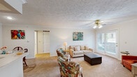 This well-appointed 2-bedroom, 2-bathroom single-story home at 340 Providence Hill Dr in Ashland, KY offers a comfortable and functional layout. The combined living and dining area serves as the heart of the home, featuring textured ceilings with decorative detail, crown molding, a ceiling fan, and access to a patio through a glass door that invites natural light. The dining space is defined by chair-rail wainscoting and offers a cozy setting for meals. The galley-style kitchen is efficiently designed with warm wood cabinetry, ample counter space, tile flooring, and includes appliances such as an electric range and dishwasher. The spacious primary bedroom comfortably accommodates a full suite of furniture and is complemented by a walk-in closet with wire shelving. The second bedroom is bright, featuring a window with natural light and carpeted flooring. Both bathrooms are well-appointed, with one featuring a tub-shower combination and tile flooring. A dedicated laundry room adds everyday convenience. Throughout the home, neutral tones and carpeted living areas create a warm, inviting ambiance suited for comfortable everyday living.