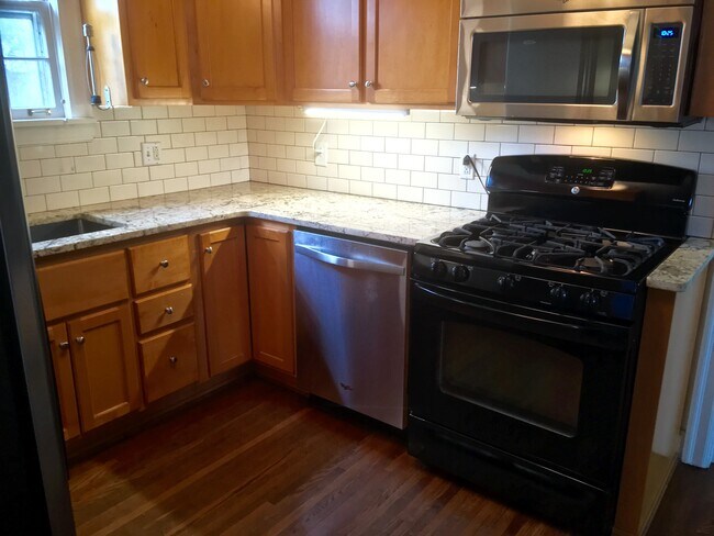 Chef's galley kitchen with stainless dishwasher and gas range - 1509 HARWOOD DR