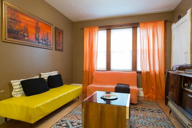 Staged pre-renovation photo of living room - 2640 West Thomas Street Apartments