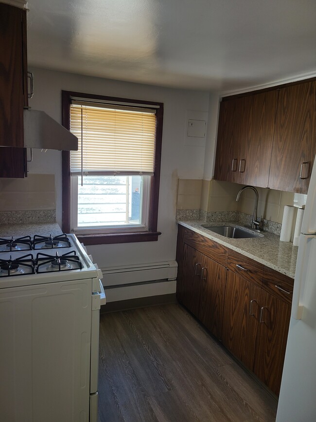Cocina con encimeras de mármol nuevas, ventana y ventilador. - 131 Depeyster St