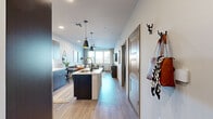Located at 7200 N 91st Ave in Glendale, Arizona, this well-appointed one-bedroom, one-bathroom residence offers a thoughtfully designed open-concept layout with modern finishes throughout. Light wood-style flooring flows seamlessly from the entry through the main living areas, creating a cohesive and inviting atmosphere.

The kitchen serves as a central feature of the space, boasting dark flat-front cabinetry that extends to the ceiling for generous storage, white quartz countertops, a tile backsplash, and a full suite of stainless steel appliances including a gas range, microwave, and French door refrigerator. A kitchen island with pendant lighting adds both function and style, connecting the kitchen to the open dining and living areas.

The living room is bright and airy, benefiting from a large window bank that fills the room with natural light and offers views of the outdoors. A ceiling fan adds to the comfort of the space.

The bedroom is a comfortable retreat featuring plush carpeting, a ceiling fan, and a generously sized window with blinds and curtains, allowing for natural light control.

The bathroom is clean and functional, featuring a full tub-shower combo with white tile surround, wood-style flooring, and dark vanity cabinetry with ample counter space.