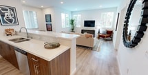 This contemporary residence in Murrieta, CA offers 1250 square feet of thoughtfully designed living space. The two-story layout encompasses 2 bedrooms and 2 bathrooms, with the primary bedroom boasting a spacious 160 square feet. The home's modern architecture is evident in its open-concept design, particularly in the combined kitchen and living room area.

The interior is characterized by clean lines and a neutral color palette, with crisp white walls throughout. Large windows with blinds allow ample natural light to flood the rooms, creating a bright and airy ambiance. The floors feature attractive light wood laminate, adding warmth to the space.

The kitchen is a highlight, showcasing sleek wood cabinets, stainless steel appliances, and quartz countertops. A center island provides additional workspace and casual dining options. The bathrooms are equally modern, with one featuring a bathtub-shower combination and contemporary fixtures.

Storage is well-considered, with a walk-in closet and built-in shelving units. The property also includes a garage with a sectional door, perfect for secure parking or additional storage.

An unexpected feature is an outdoor terrace or balcony area, offering a private space for relaxation or entertaining. The property's multiple staircases suggest an interesting multi-level layout, adding architectural interest to the home.

Overall, this property presents a harmonious blend of style and functionality, ideal for those seeking a contemporary living space in a desirable Californian location.