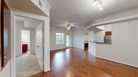 Located at 1760 Barker Cypress Rd in Houston, TX, this single-story, 3-bedroom, 2-bathroom home offers a well-designed layout with a comfortable and functional flow throughout. The open-concept living and kitchen area serves as the heart of the home, featuring rich hardwood flooring, crown molding, and a ceiling fan with light. Natural light fills the space through multiple windows, including a glass door that opens to the exterior. The kitchen is outfitted with warm cherry wood cabinetry, granite countertops, a stainless steel refrigerator, a dishwasher, and a breakfast bar that connects seamlessly to the living area. Built-in shelving provides additional storage and display space. The three bedrooms are carpeted for comfort, each equipped with a ceiling fan and window. The primary bedroom includes its own walk-in closet with wire shelving. The bathrooms feature tile flooring, rich wood vanities with stone countertops, and a tub-shower combination with full tile surround. Three closets throughout the home ensure ample storage. A dedicated laundry room with washer hookups adds everyday convenience. The layout is efficient and cohesive, making excellent use of the available space throughout.
