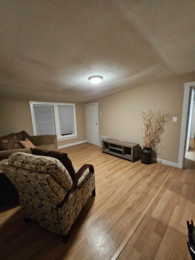 Living room with couch, chair, entertainment center - 1027 N 3rd St