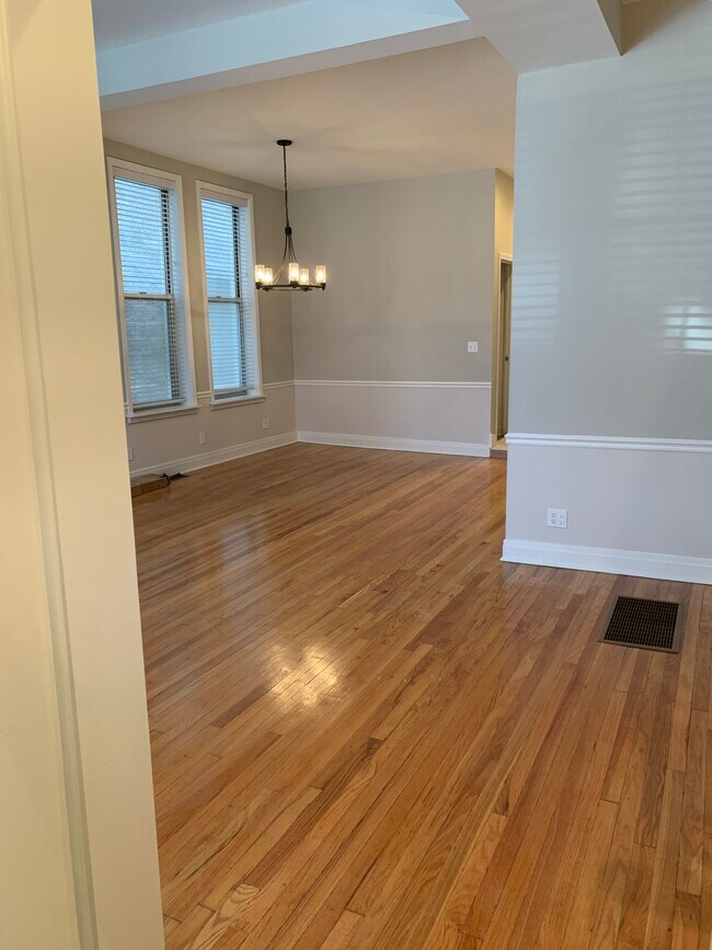 Dining room leads to eat-in kitchen, full bath and bedroom 1. - 1648 N Claremont Ave