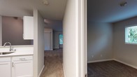 This single-floor residence is thoughtfully laid out across several well-defined spaces connected by a central hallway. The kitchen stands out with its clean, contemporary design, showcasing white shaker-style cabinetry, stainless steel appliances including a refrigerator, range, microwave, and dishwasher, complemented by white countertops and a stainless steel sink. Wood-look flooring runs throughout the kitchen, adding warmth and durability to the space.

The living area is generously sized, featuring plush carpeting, a ceiling fan with light fixture, and a large window that allows natural light and outdoor views of surrounding greenery. A sliding glass door with vertical blinds provides additional access and light. A separate room features a fireplace with a tile surround and white mantel, making it a comfortable focal point.

The bedrooms are carpeted and well-lit by windows with blinds offering outdoor views. One bedroom includes a closet with bifold doors and built-in rod for storage. The bathroom is finished with wood-look flooring and offers both a standalone walk-in shower and a separate soaking tub/shower combination, alongside a toilet, providing functional flexibility.