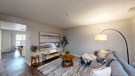 Located at 3637 Sonoma Ave in Santa Rosa, CA, this two-story, 2-bedroom, 3-bathroom home offers a well-designed layout across two floors. The main level features rich wood-style flooring throughout, anchored by a welcoming living room with a sliding glass door that brings in natural light and provides outdoor access. The open-concept kitchen is outfitted with white shaker cabinets, stainless steel appliances including a gas range and refrigerator, and a peninsula with a dark countertop that doubles as a breakfast bar. The adjacent dining area also benefits from a sliding glass door leading to a private patio, filling the space with greenery views and additional natural light. A staircase with white railings connects the floors with clean, classic styling. Upstairs, the generously sized primary bedroom features plush carpeting, a large window with outdoor views, and a frosted-glass door leading to an en-suite bathroom. The additional bedroom is similarly carpeted and bright. The three bathrooms are finished with neutral tones, wood-style flooring, and include tub-shower combinations. Throughout the home, a consistent neutral color palette and textured ceilings create a clean, comfortable atmosphere.