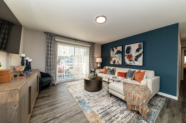 Spacious living room with hardwood-style flooring & overhead lighting - The Linden Apartment Homes