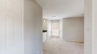 Located at 3301 River Park Dr in Fort Worth, TX, this well-designed one-bedroom, one-bathroom unit makes smart use of its compact footprint across a single floor. The layout includes a kitchen, bedroom, bathroom, and hallway, offering a functional and cohesive flow throughout.

The kitchen is a standout feature, equipped with stainless steel appliances including a refrigerator, electric range, and over-the-range microwave. White cabinetry pairs with dark countertops for a clean, modern contrast, while a peninsula with a double sink adds counter space and separates the kitchen from the living area. Pendant lighting and a flush-mount ceiling fixture provide ample illumination, and large windows with blinds allow natural light to fill the space.

The bedroom is carpeted and comfortably sized, featuring a ceiling fan with light, a window overlooking the outdoors, and a built-in closet with sliding doors and organized shelving — providing practical storage solutions.

The bathroom is clean and straightforward, offering a full tub-shower combination with white tile surround, chrome fixtures, and a standard toilet. The overall aesthetic throughout the unit is neutral and bright, with light gray walls, white trim, and a mix of tile and carpet flooring that transitions naturally between spaces.
