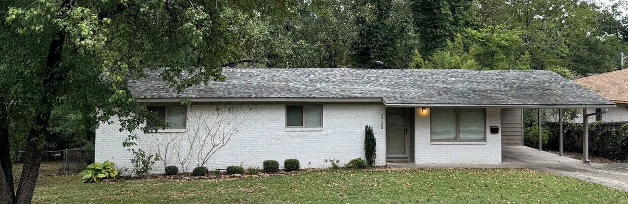 Neat landscaped yard with carport. - 3708 Idlewild Ave