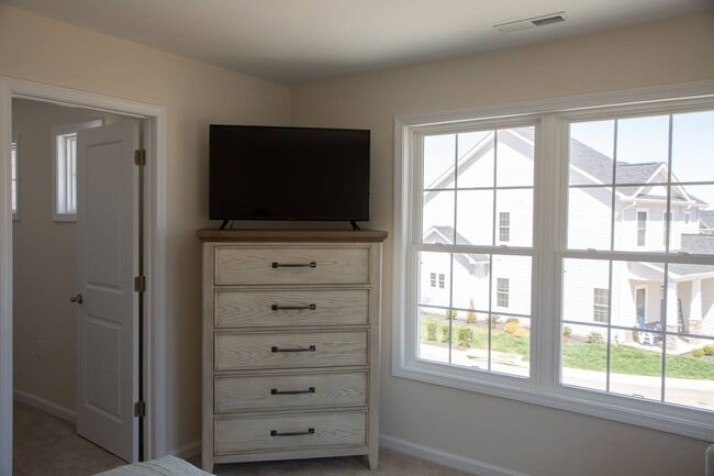 Primary Bedroom Dresser/Roku TV, Walk in closet - 239 Louise Ln