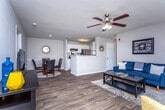 Located at 6103 Leafstone Dr in Covington, Georgia, this single-story home offers a well-designed layout with a comfortable, neutral aesthetic throughout. The living room serves as the heart of the home, featuring wood-look flooring, a ceiling fan with light fixture, and large windows that allow natural light to fill the space. The kitchen is outfitted with white cabinetry, light countertops, and black appliances, with direct access to a dedicated laundry area housing a full washer and dryer alongside the water heater. Each bedroom is carpeted and equipped with a ceiling fan, natural light from window panels, and ample room for furnishings. The bedrooms share a consistent warm, neutral color palette with soft gray walls. Two full bathrooms are finished with wood-look flooring, white vanity cabinets, light countertops, and tub-shower combinations. The bathrooms feature textured ceilings and mirror-topped vanities, providing practical and clean-lined utility. The overall design of this home prioritizes functionality and comfort, with consistent finishes across all rooms creating a cohesive, move-in-ready environment in the Covington, GA area.