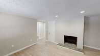 Located at 147 Pinney St in Ellington, Connecticut, this one-bedroom, one-bathroom unit offers a well-organized, efficient layout across a single floor. The living room serves as the heart of the home, highlighted by a painted brick fireplace wall that adds character and warmth to the space. Light wood-style flooring runs throughout, complemented by neutral beige and white walls, creating a clean and cohesive aesthetic. Textured ceilings and recessed lighting add architectural detail, while baseboard heating ensures comfort year-round. Natural light filters in through windows fitted with blinds, and a private entry door with transom window provides direct access to the living area. The bedroom is generously proportioned, featuring two closets for ample storage, a window for natural light, and access to additional rooms via the hallway. The kitchen is thoughtfully appointed with white shaker-style cabinetry, light countertops, a stainless steel refrigerator, stainless electric range, and a built-in sink with modern fixtures — all illuminated by a central flush-mount ceiling light. The bathroom includes a walk-in shower unit, toilet, and vanity, finished with warm neutral tones and brushed nickel hardware. Two closets throughout the unit offer practical storage solutions.
