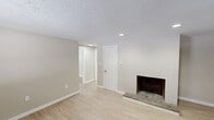 Located at 147 Pinney St in Ellington, Connecticut, this one-bedroom, one-bathroom unit offers a well-organized, efficient layout across a single floor. The living room serves as the heart of the home, highlighted by a painted brick fireplace wall that adds character and warmth to the space. Light wood-style flooring runs throughout, complemented by neutral beige and white walls, creating a clean and cohesive aesthetic. Textured ceilings and recessed lighting add architectural detail, while baseboard heating ensures comfort year-round. Natural light filters in through windows fitted with blinds, and a private entry door with transom window provides direct access to the living area. The bedroom is generously proportioned, featuring two closets for ample storage, a window for natural light, and access to additional rooms via the hallway. The kitchen is thoughtfully appointed with white shaker-style cabinetry, light countertops, a stainless steel refrigerator, stainless electric range, and a built-in sink with modern fixtures — all illuminated by a central flush-mount ceiling light. The bathroom includes a walk-in shower unit, toilet, and vanity, finished with warm neutral tones and brushed nickel hardware. Two closets throughout the unit offer practical storage solutions.