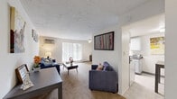 Located at 625 Loop Rd in Kent, Ohio, this single-floor, two-bedroom, two-bathroom unit offers a practical and comfortable layout. The living room serves as the central gathering space, featuring wall-to-wall carpet, a ceiling fan, a wall-mounted AC unit, and a large sliding glass door fitted with vertical blinds that draws in generous natural light. Adjacent to the living room, the galley-style kitchen is efficiently designed with gray cabinetry, dark laminate countertops, a stainless steel sink, a gas range, and a full-size refrigerator, with light tile flooring throughout. The spacious primary bedroom offers room for a full furniture arrangement, includes carpet flooring, a wall AC unit, and a large window with vertical blinds. The second bedroom is similarly carpeted and well-lit. Hallways connect the rooms with built-in closet storage featuring bifold doors. Both bathrooms are equipped with tub-shower combinations and white tile surrounds — one showcasing mosaic tile flooring and white cabinetry, the other with classic finishes and a wood-toned vanity. Baseboard heating is present throughout the unit, complementing the wall AC units for year-round climate control.