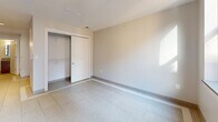 Located at 1249 Griswold in the heart of downtown Detroit, this one-bedroom, one-bathroom unit offers a thoughtfully designed layout making efficient use of its space. The interior is finished with large-format light tile flooring throughout, neutral warm-toned walls, and clean modern trim, creating a bright and cohesive aesthetic.

The spacious bedroom features a generous built-in closet with shelving and hanging rods, offering ample storage. Natural light enters through a black-framed window that frames views of the surrounding historic brick architecture, adding character to the room.

The kitchen is well-appointed with rich dark wood cabinetry, light countertops, recessed lighting, and a full suite of stainless steel appliances, including a range, microwave, dishwasher, and refrigerator. The layout is efficient and functional, ideal for everyday cooking.

The bathroom is finished with classic hexagonal mosaic floor tile, large-format wall tile in the shower enclosure, a glass sliding shower door, and a wood-toned vanity with a neutral countertop — consistent with the modern design language found throughout the unit.

Overall, this unit offers a clean, move-in-ready space with contemporary finishes in a prime downtown Detroit location.