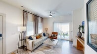Located in Fort Worth, TX, this thoughtfully designed 2-bedroom, 3-bathroom multi-story residence offers a contemporary living experience across two active floors. The ground floor features an open-concept living room and kitchen layout bathed in natural light from large windows and a sliding glass door that leads to a private outdoor space. The living area is appointed with wood-style flooring, a ceiling fan, and neutral-toned walls that create a bright, welcoming ambiance. The kitchen is a standout, showcasing granite countertops, a generous island with seating, sleek gray cabinetry, stainless steel appliances, and a subway tile backsplash. A convenient half bathroom is also located on this floor. Upstairs, the primary bedroom is a comfortable retreat featuring plush carpeting, tall ceilings, abundant natural light from dual windows, a closet, and direct access to an en-suite bathroom with gray vanity cabinetry. The second bedroom is equally well-appointed, also with carpet and ample natural light. Additional bathrooms include a full bath with a subway-tiled tub/shower combination. The hallway and closets complete the upper floor, providing practical storage throughout. The overall aesthetic is clean, modern, and cohesive.