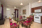 Located in New Orleans, LA, this single-floor residence offers a thoughtfully designed layout that balances comfort and functionality. The living area features light hardwood-style flooring, neutral walls, and ample space for seating, creating a clean and inviting atmosphere.

The kitchen is well-equipped with rich dark wood cabinetry extending to the upper walls, generous counter space, and a full suite of white appliances including a range, built-in microwave, dishwasher, and refrigerator. A pendant light fixture adds a warm focal point, and the adjoining dining area accommodates a full table setting.

Multiple bedrooms are carpeted and feature neutral tones, natural light from double-hung windows with blinds, and tasteful wall décor. Each room offers a comfortable, restful environment with understated design details.

Two full bathrooms serve the residence, each featuring dark wood vanity cabinetry, white countertops, tile flooring, and large mirrors above the sinks. One bathroom includes a shower-tub combination, while the other is configured as a compact, efficient space. Both are clean and well-appointed, providing practical functionality throughout the home.