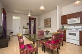 Located in New Orleans, LA, this single-floor residence offers a thoughtfully designed layout that balances comfort and functionality. The living area features light hardwood-style flooring, neutral walls, and ample space for seating, creating a clean and inviting atmosphere.

The kitchen is well-equipped with rich dark wood cabinetry extending to the upper walls, generous counter space, and a full suite of white appliances including a range, built-in microwave, dishwasher, and refrigerator. A pendant light fixture adds a warm focal point, and the adjoining dining area accommodates a full table setting.

Multiple bedrooms are carpeted and feature neutral tones, natural light from double-hung windows with blinds, and tasteful wall décor. Each room offers a comfortable, restful environment with understated design details.

Two full bathrooms serve the residence, each featuring dark wood vanity cabinetry, white countertops, tile flooring, and large mirrors above the sinks. One bathroom includes a shower-tub combination, while the other is configured as a compact, efficient space. Both are clean and well-appointed, providing practical functionality throughout the home.