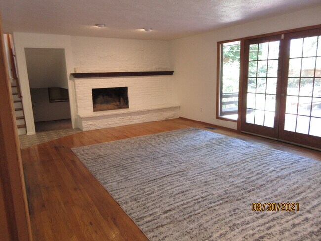 living room, fireplace, slider to backyard - 10905 E 19th Ave