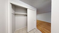 This 740 square foot apartment in Everett, Washington, offers a well-designed living space on a single floor. The property features one bedroom measuring 160 square feet, complemented by one full bathroom. The kitchen and living room are combined in an open-plan layout, maximizing the use of space.

The bathroom is finished with light-colored tile and includes a spacious shower area. The kitchen boasts wooden cabinets, granite countertops, and stainless steel appliances, creating a modern and functional cooking space. The living area is brightened by a large window, allowing natural light to flood the room, and features warm hardwood flooring that extends throughout most of the apartment.

The bedroom, also with hardwood floors, includes a ceiling fan for comfort and a closet for storage. Additional storage is provided by a second closet in the apartment. The property's design emphasizes clean lines and neutral colors, creating a contemporary feel throughout. Circular light fixtures and baseboard heating add to the overall modern aesthetic of this compact yet efficiently designed living space.