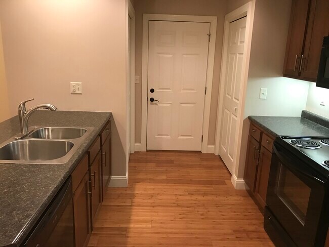 Garage entrance door into kitchen. Coat closet and large pantry at entrance. - 206 Stallion Way