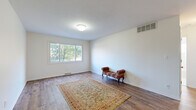 Located at 24350 Lake Shore Blvd in Euclid, Ohio, this well-maintained 2-bedroom, 1-bathroom unit offers a thoughtfully laid-out single-floor living space with a clean, neutral aesthetic throughout.

The living room is a welcoming area featuring rich wood-look flooring, crisp white walls, and a large window that fills the room with natural light and views of surrounding greenery. The space flows seamlessly into a dining area, creating an open and functional layout ideal for everyday living.

The kitchen is a standout feature, offering warm honey-toned cabinetry with arched detailing, white appliances including a gas range, microwave, and dishwasher, as well as a tile backsplash and a breakfast bar with seating. Wood-look flooring continues throughout, tying the space together cohesively.

Both bedrooms are carpeted for comfort and feature large windows dressed with vertical or horizontal blinds, allowing for adjustable natural light. The rooms are simply designed with clean white walls, offering a versatile canvas for personalization.

The full bathroom is finished in classic white tile, featuring a tub/shower combo with a curtain rod, a vanity with storage, and a small window for ventilation. The bright, clean finishes give the bathroom a fresh and functional feel throughout.