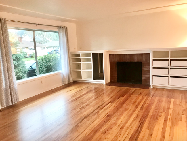 fireplace for cozy winter evenings and huge windows making the space light and bright - 2520 SE 79th Ave