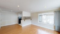 Located at 1901 Montecito Avenue in Mountain View, California, this single-floor, one-bedroom, one-bathroom unit offers a well-organized and efficient layout. Warm hardwood flooring flows throughout the main living areas, creating a bright and inviting atmosphere. The front entry door features a charming arched window detail, welcoming you into a hallway that opens to the spacious living room, which benefits from multiple windows that draw in generous natural light and offer views of the surrounding neighborhood.

The kitchen and dining area are thoughtfully combined, with the kitchen featuring white cabinetry, granite-style countertops, a stainless sink, a coil cooktop, and a full-size refrigerator. A peninsula countertop with bracket shelving serves as a functional dining bar, seamlessly connecting the kitchen to the living space. Recessed lighting throughout keeps the areas bright and well-illuminated.

The bedroom is a comfortable, well-proportioned room with hardwood floors, a large window with outdoor views, and access to ample closet storage — three closets in total are found within the unit. The full bathroom includes a tiled tub-shower combination with sliding glass doors, tile flooring, and a vanity with a white cabinet. The overall aesthetic is clean, neutral, and move-in ready.