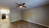 Located in Clemmons, NC, this two-story, 4-bedroom, 2-bathroom home offers a practical and well-organized layout across two floors. The main level hosts the kitchen, a hallway, a utility room, and living areas, while the upper level accommodates the bedrooms. The spacious primary bedroom features warm carpeting, a ceiling fan with light, and a window that brings in natural light, creating a comfortable retreat. The additional bedrooms on the lower level are finished with rich, dark hardwood-style flooring and ceiling fans, providing a consistent and polished aesthetic throughout. The kitchen is well-equipped with white shaker-style cabinetry, light countertops, a textured tile backsplash, and black appliances including a refrigerator, electric range, and dishwasher, all set atop light wood-look flooring. The two bathrooms are clean and functional, featuring a tub/shower combo with chrome fixtures and a separate water closet. A dedicated utility room adds everyday convenience. Neutral gray walls, white trim, and ceiling fans throughout the home contribute to a cohesive, move-in-ready feel. A staircase connects the two floors, as seen in the dollhouse overview of the home's efficient and thoughtfully arranged floor plan.