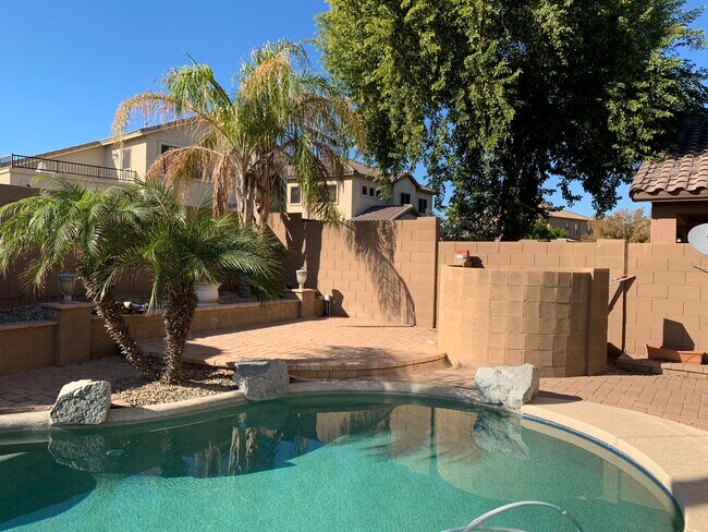 Spacious 4-bedroom, 2-bath home with soaring ceilings, gourmet kitchen, and a heated self-cleaning p - 16426 N 152nd Ln