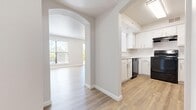 This single-story residence offers a well-organized layout with 5 bedrooms and 3 bathrooms, designed with a clean, neutral palette and modern finishes throughout. The open-concept living area is bright and airy, featuring light hardwood-style flooring, vaulted ceilings with a ceiling fan, and large windows that invite abundant natural light. A sliding door in the living room provides access to an outdoor area with views of surrounding greenery and hills, enhancing the sense of openness.

The kitchen is efficiently designed with crisp white cabinetry, a stainless steel sink, ample counter space, and black appliances including a range, dishwasher, and refrigerator. A charming arched passageway connects the kitchen to the living area, adding an architectural detail that enhances the flow between spaces.

The five bedrooms are carpeted and offer a comfortable, quiet atmosphere, each benefiting from natural light through blinds-fitted windows. Select bedrooms include walk-in closets, providing practical storage solutions. The three bathrooms are finished in white with tub-shower combinations and wood-style flooring. A dedicated laundry area with a full-size washer and dryer adds everyday convenience. Hallways connect the rooms efficiently, making this a functional and well-appointed single-level home.