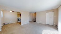 Located at 40 Chapman Blvd in Somers Point, New Jersey, this single-floor residence offers a practical and comfortable layout with a neutral, warm color palette throughout. The kitchen is efficiently designed with warm wood-toned cabinetry, a gas range, dishwasher, refrigerator, and a double sink, complemented by tile flooring and under-cabinet task lighting. A ceiling fan overhead adds to the kitchen's functionality. The open living and dining areas feature plush wall-to-wall carpeting, baseboard heating, and ceiling fans, creating a comfortable, well-ventilated environment. Multiple windows fitted with blinds allow natural light to fill the space. The living room benefits from a sliding glass door that invites additional light and provides outdoor access. Multiple bedrooms are carpeted and generously sized, each equipped with ceiling fans, windows for natural light, and baseboard heating. Select bedrooms include built-in closets for convenient storage. The bathroom is finished with classic white tile wainscoting, a vanity with sink, and a clean, functional layout. Throughout the residence, the consistent warm beige tones and practical finishes create a cohesive and welcoming living environment.