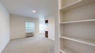 Located at 1948 Linwood St NW in Salem, Oregon, this well-designed one-bedroom, one-bathroom unit offers a comfortable and functional single-floor layout. The open-concept kitchen and living area forms the heart of the home, bathed in natural light from multiple windows dressed with horizontal blinds. The kitchen is outfitted with warm wood-toned cabinetry, sleek white countertops, stainless steel appliances including an electric range and microwave, and light wood-look flooring that extends throughout the main living space. A breakfast bar provides a natural partition between the kitchen and the living area, which offers a clean, neutral palette and a cozy fireplace, creating an inviting atmosphere. The bedroom is a comfortable retreat featuring plush wall-to-wall carpeting, a generous sliding-door closet, and a window that allows natural light and neighborhood views. The bathroom is finished with a wood-toned vanity, white countertop, a well-lit mirror, and coordinating hardware, maintaining the consistent modern aesthetic found throughout the unit. Neutral tones, clean lines, and an abundance of natural light give the entire space a bright, move-in-ready feel.