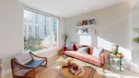 Located at 1515 Surf Ave in Brooklyn's Coney Island neighborhood, this thoughtfully designed one-bedroom, one-bathroom residence offers a bright and efficient layout with modern finishes throughout. Light wood flooring runs seamlessly across the entire space, contributing to a clean, cohesive aesthetic.

The open-plan kitchen and living area forms the heart of the home. The kitchen is outfitted with sleek, floor-to-ceiling white cabinetry, a textured tile backsplash, white quartz countertops, stainless steel appliances including a range, microwave, and refrigerator, and a central island with bar seating — ideal for dining or entertaining. The adjoining living area is anchored by large picture windows that flood the space with natural light and offer views of the surrounding neighborhood.

The bedroom is a well-proportioned retreat featuring its own window with outdoor views, a closet, and the same warm wood flooring. The bathroom is finished in a contemporary style with large-format tile, a floating vanity, an illuminated mirror, and a bathtub with shower.

A hallway connects the rooms efficiently, and a dedicated closet provides additional storage. The residence's clean lines, neutral palette, and abundant natural light create a calm, modern ambiance throughout.